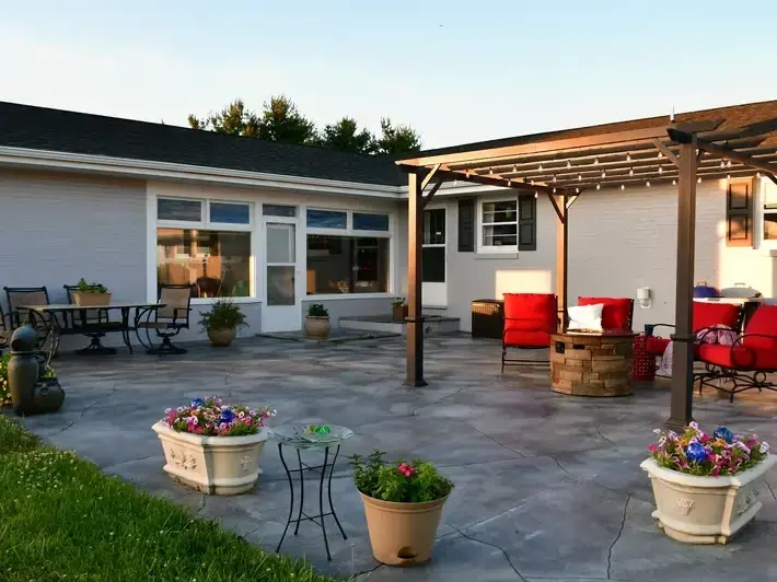 custom patio and retaining wall design at a Bellevue home with slope drainage planning